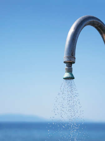 Shower with flowing Water against the backdrop of an azure sea. vertical.の写真素材