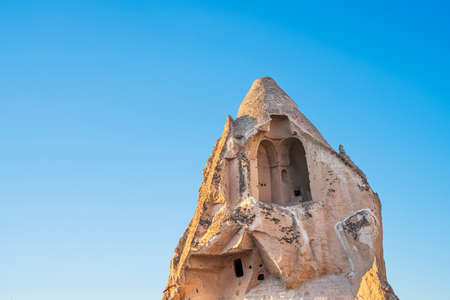Ancient stone dwellings at sunset in Goreme in Cappadocia, Turkey.の写真素材