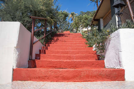 Red staircase uphill with stone steps. Bodrum.の写真素材