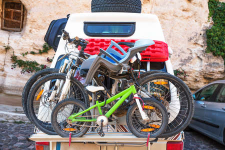 Car transports bicycles on a rack in early morningの写真素材