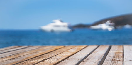 Empty wooden deck on the background of a white yacht.