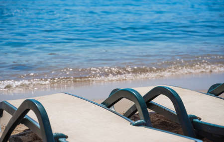 sun loungers on the sandy beach, close-up.の写真素材