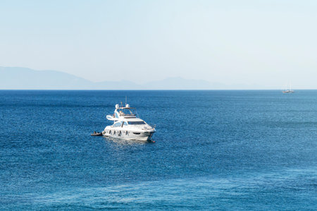 Sea bay with a large modern private yacht in the roadstead.
