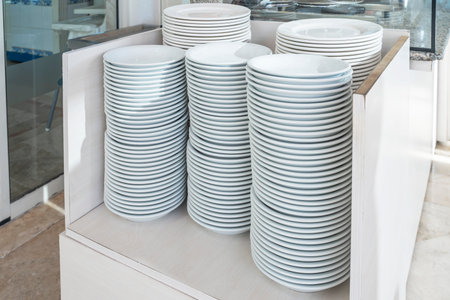 Set of white dishes on the table in a buffet restaurant.