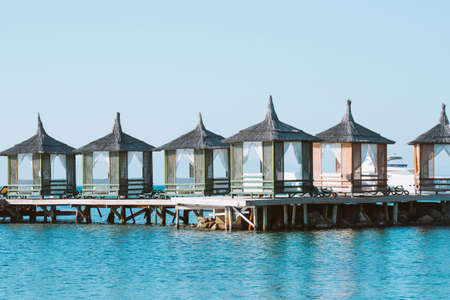 summer pavilions with curtains on a wooden pier. Summer holiday concept.の写真素材