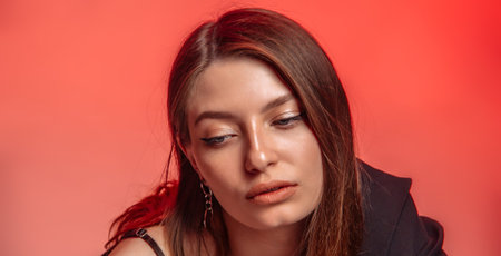 Young woman with healthy skin. Model with perfect skin does not look at the camera on a pink background.の写真素材