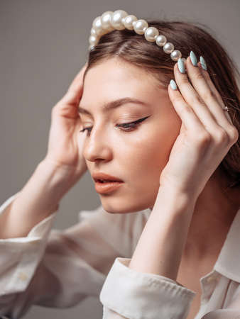 Young woman massages her face hand. Close-up.の写真素材