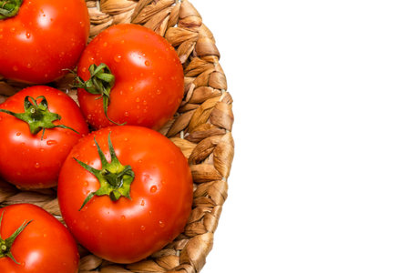 fresh tomatoes in a basket on a white background,tomatoes in the basketの写真素材