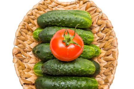 vegetables in basket on a grass,cucumbers and tomatoes in the basket,the basket of vegetables,juicy ripe vegetablesの写真素材