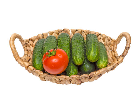 vegetables in basket on a grass,cucumbers and tomatoes in the basket,the basket of vegetables,juicy ripe vegetablesの写真素材