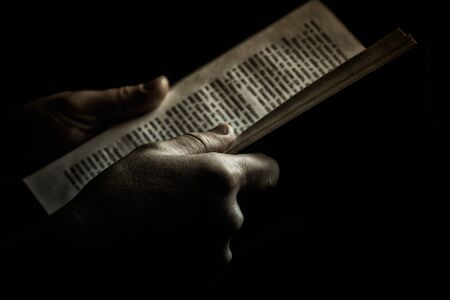 Looking thruogh book with motion blur on black backgroundの写真素材