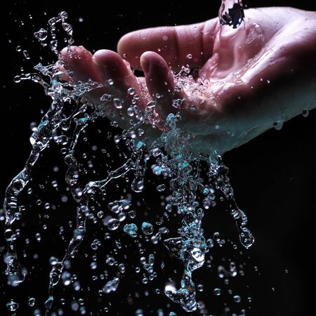 Water stream on woman handの写真素材