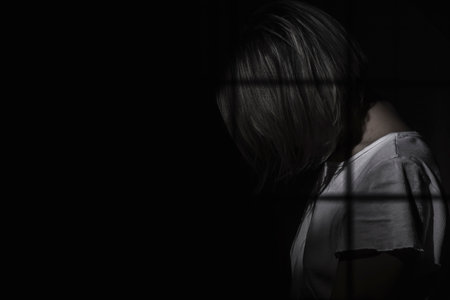 the girl behind the bars,black backgroundの写真素材
