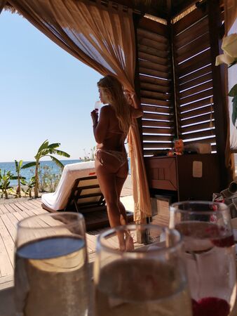 Beautiful girl on the beach on a Sunny day in a romantic setting by the blue sea, Beautiful girl on the beach on a sunny day in a romantic setting by the blue seaの写真素材