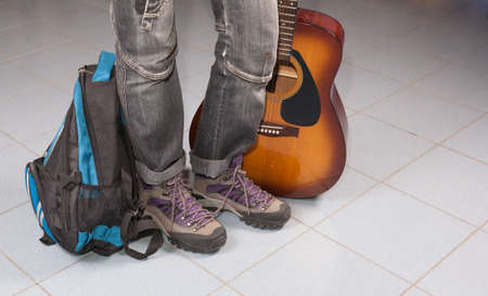 Voyager foot with a backpack and a guitarの写真素材