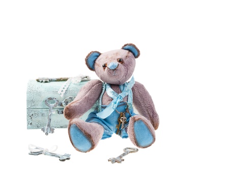 Teddy bear with keys isolated on white backgroundの写真素材