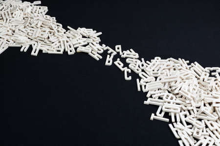 Dimensional letters scattered on a Black  backgroundの写真素材