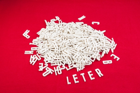 Dimensional letters scattered on a red backgroundの写真素材