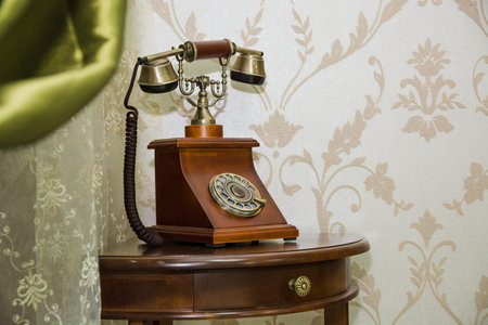 Old phone costs on a table at a wallの写真素材