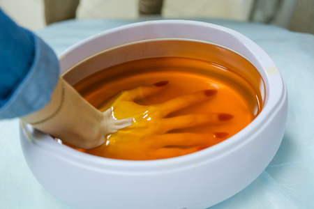 Wax bathtub for moistening of hands. Cosmetic waxの写真素材