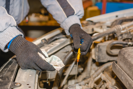 The man checks oil level in the car. Check of technical liquids of the car.の写真素材