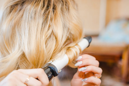 The woman twists hair. The woman does a hairの写真素材