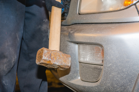 The man breaks the car. The angry man breaks the carの写真素材