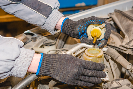 The man checks oil level in the car. Check of technical liquids of the car.の写真素材