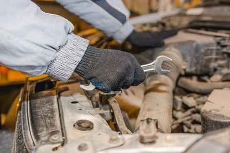 The man repairs the car. Maintenance of the car.の写真素材