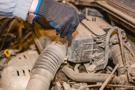 The man repairs the car. Maintenance of the car.の写真素材