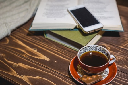 The girl reads the book and has coffee. Rest and reading house. Read to a hobby books.の写真素材