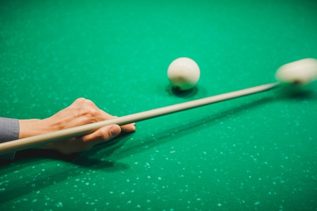 To play billiards. The man plays billiards. Desktop gambling. To hit into a sphere.の写真素材