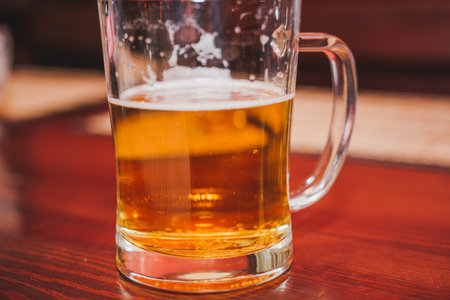 Glass of beer. Golden beer in a circle. A mug with the handle under beer.の写真素材