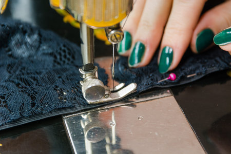 Sewing on the machine. To sew on the ancient machine. The manual machine for sewing.