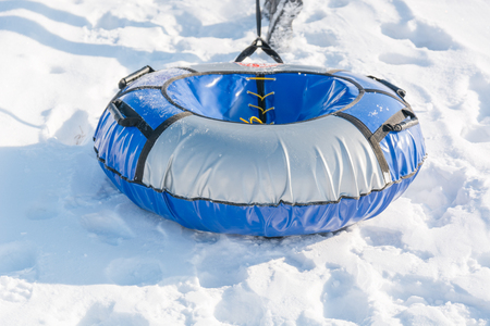 Children ride on tubing. Winter entertainment. Skiing in the winter. Snowy fun in the winter. Fun in the winter. Tubing. People roll on the slides.の写真素材