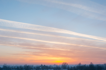 Sunset in winter. Orange sun in the winter in the snow. Beautiful winter sunset.の写真素材