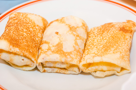 Stuffed pancakes. Pancakes with cottage cheese. Cooking pancakes. Wrap up the pancakes with cottage cheese. Natural food.の写真素材