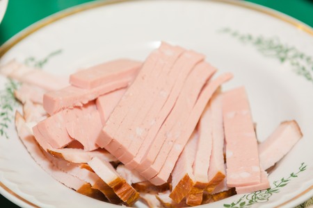 The sausage is chopped on a plate. Sausage cut. Slices of sausage on a plate. Sliced sausage.の写真素材