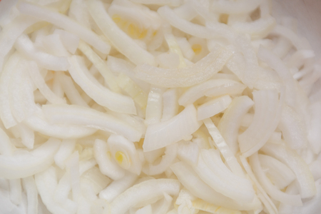 Sliced onions. Background bow. Fresh onions on the table. Large bowの写真素材