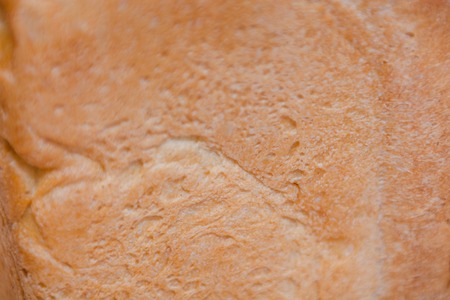 The texture of the crust of bread. Hot fresh bread. Bread close up. A piece of bread. Daily breakfast.の写真素材
