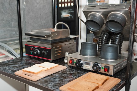 A device for making sweet waffles. Apparatus in the kitchen. The device in the restaurant for cooking desserts.の写真素材