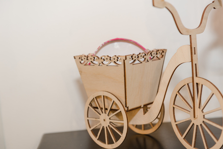 Wooden toy on the shelf. Men's children's game. Bicycle model with a trailer. Wooden bike Beautiful wooden toyの写真素材