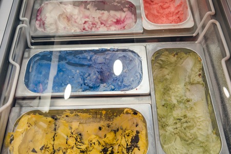 Delicious ice cream in trays. A variety of ice cream in the store. Sweet ice cream. Frozen milk with vanilla. Favorite summer treatの写真素材