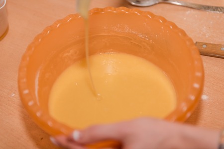The girl kneads the dough. Home cooking. Mix the ingredients for the test. Natural food. Cookingの写真素材