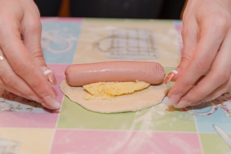 The girl makes pies with sausage and potatoes. natural products. Delicious food. homemade foodの写真素材