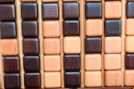 Children play a logic game with wooden cubes. Board game. Educational game for childrenの写真素材