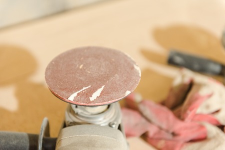 Sander. Sand wooden products. A man works with a grinding machine. Carpentry workshop. Make the tree smooth.の写真素材