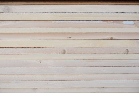 View of the stack of boards. Boards closeup. Wood texture. Background tree.