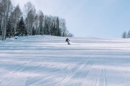 Snowboarding from a snowy mountain.の写真素材