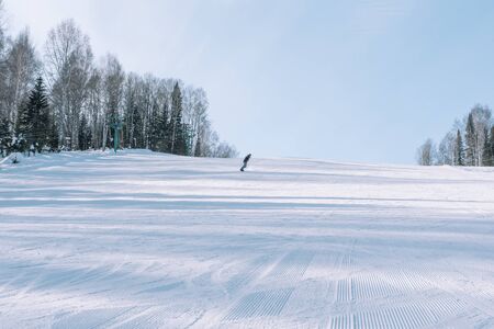 Snowboarding from a snowy mountain.の写真素材